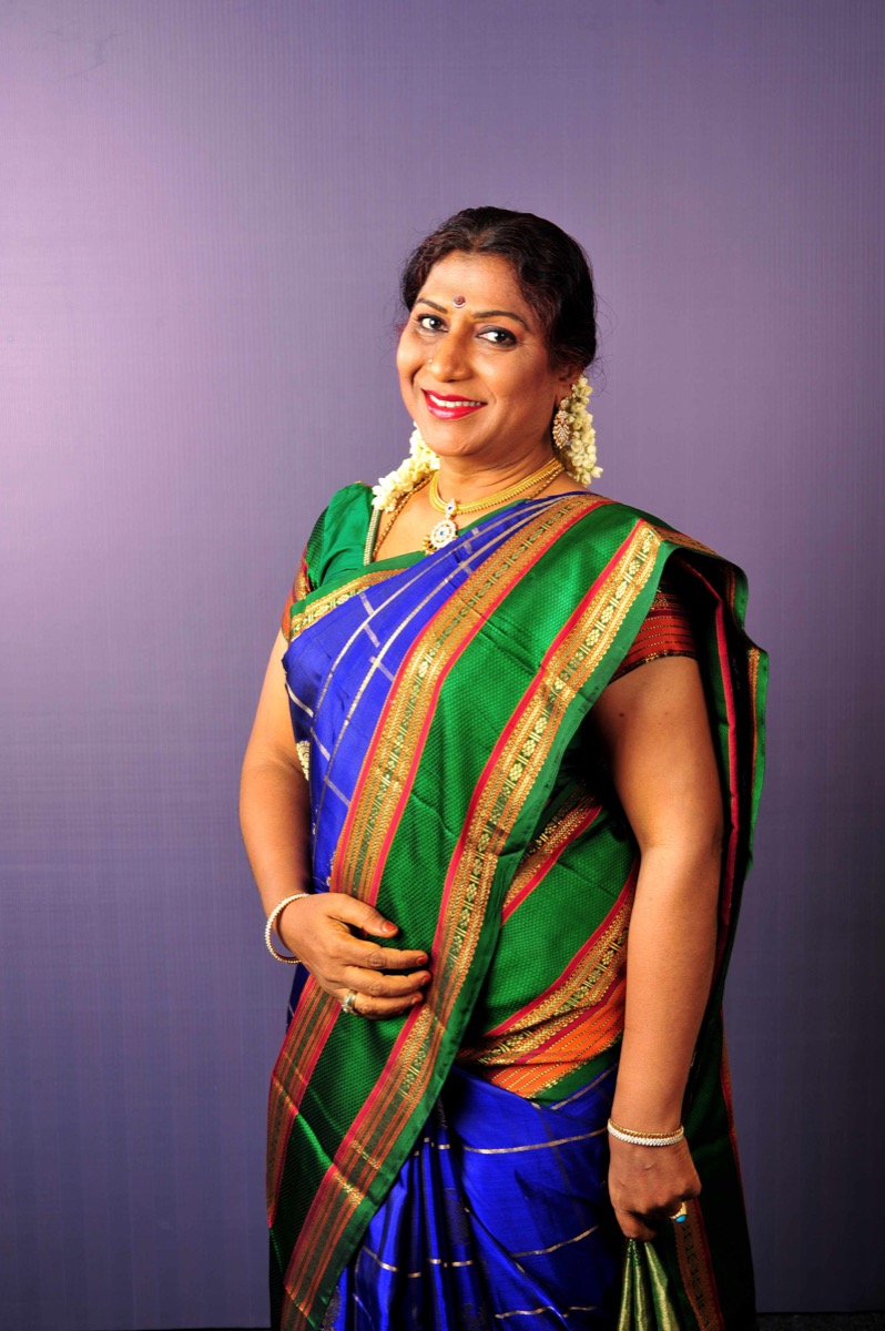 Portrait of Narthaki Nataraj wearing a green and blue silk sari